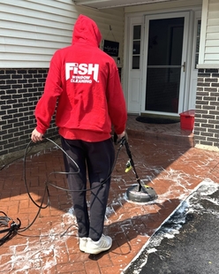 Local FISH team pressure washing an exterior surface