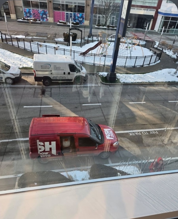 Red FISH van outside a Chicago-area commercial window cleaning job in winter